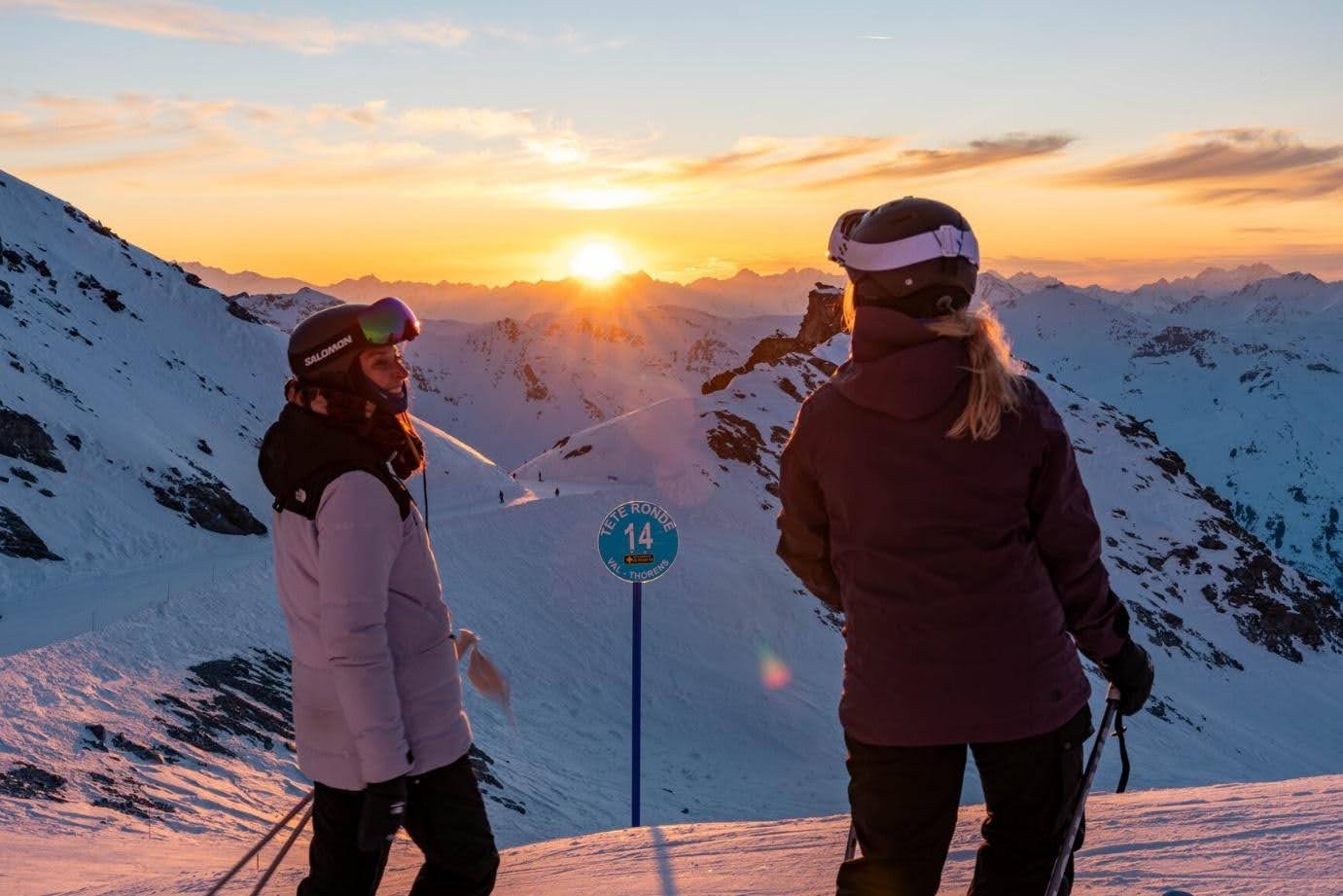 Skiers overlooking snowy mountains